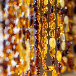 Amber background of beads and necklaces at the handicraft market. Traditional Souvenirs From Baltic